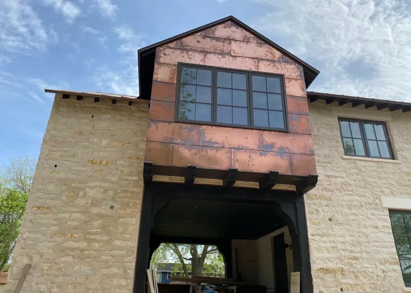 Copper metal panel facade on a stone building for Metal Roof Coating in Lee